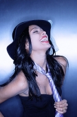 Young woman, wearing hat and tie, laughing - Asia Images Group