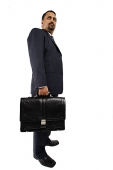 Businessman standing and holding briefcase - Asia Images Group