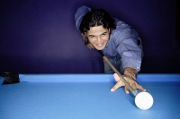 Man shooting pool - Asia Images Group