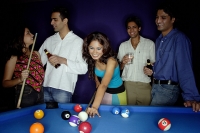 Young adults playing pool and drinking beer - Asia Images Group