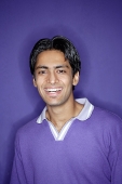 Young man wearing purple shirt smiling at camera - Asia Images Group