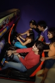 Young adults in amusement arcade - Asia Images Group