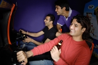 Young men in amusement arcade - Asia Images Group