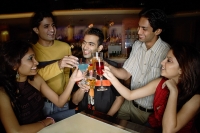Young adults toasting drinks in club - Asia Images Group