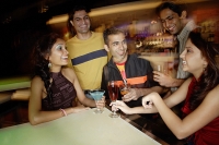 Young adults having drinks in club - Asia Images Group