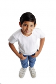 Boy standing with hands in pocket, smiling at camera - Asia Images Group