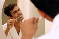 Man brushing his teeth - Asia Images Group