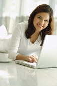 Woman at home with laptop - Asia Images Group