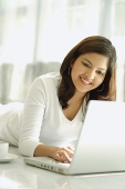 Woman at home with laptop - Asia Images Group