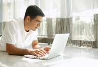 Man using laptop at home - Asia Images Group