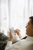 Businessman using PDA - Asia Images Group