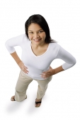 Woman with hands on hips, smiling at camera - Asia Images Group