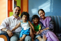 Family with two children, smiling at camera - Asia Images Group