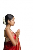 Woman in traditional Indian costume, standing with hands together, side view - Asia Images Group