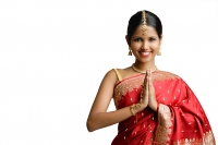 Woman in red sari, standing with hands together, smiling at camera - Asia Images Group