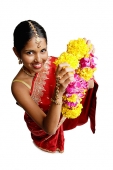 Woman in sari, holding flower garland, high angle view - Asia Images Group