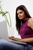 Woman sitting, using laptop - Asia Images Group