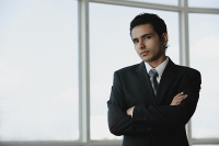 Young businessman arms crossed - Asia Images Group