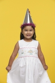 Young girl in white dress and party hat - Asia Images Group