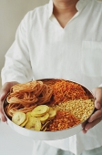 A man holds a chips platter - Asia Images Group