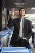 Man gesturing and looking up - Asia Images Group