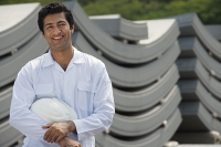 Man in work uniform, smiling at camera - Asia Images Group