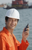 Man in work uniform smiling at camera - Asia Images Group