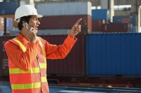 Man in work uniform talking on mobile phone - Asia Images Group