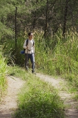 Young man hiking in the wilderness - Asia Images Group