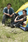 Two friends camping smiling at camera - Asia Images Group