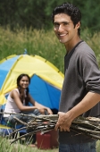 Young couple camping in high grass - Asia Images Group