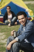 Young man camping with girlfriend - Asia Images Group