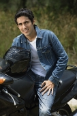 Young man riding motorbike - Asia Images Group