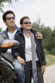 Young couple with motorbike - Asia Images Group