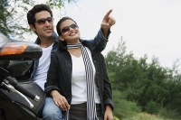 Young couple with motorbike - Asia Images Group