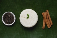 Still life of cinnamon sticks, black pepper and basmati rice - Asia Images Group