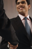 Businessman smiling and shaking hands - Asia Images Group