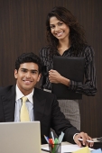 Businessman and woman smiling at camera - Asia Images Group
