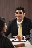 Businessman smiling at woman - Asia Images Group