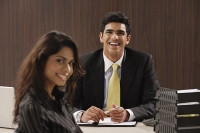 Businessman and woman smiling at camera - Asia Images Group