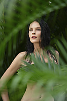 naked woman behind tropical leaves - Alex Mares-Manton