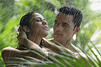 couple standing in tropical rain - Alex Mares-Manton