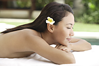 woman lying outside on massage table - Cedric Lim
