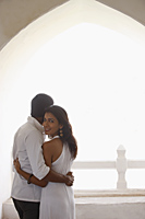couple wearing all white, embracing, woman looking back - Vivek Sharma