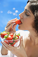 Woman eating strawberry - Alex Mares-Manton