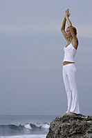 woman practicing yoga on rocks - Alex Mares-Manton