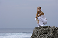 woman on rocks, watching ocean - Alex Mares-Manton