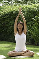 woman practicing yoga outside - Cedric Lim