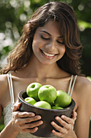 woman holding bowl of apples - Alex Mares-Manton