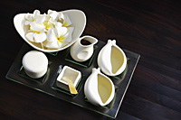 Set of white vessels on tray, Frangipani flowers in bowl - Alex Mares-Manton